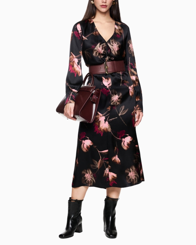 Model wearing Marc Cain black floral silk dress, front view with V-neck and gathered waist