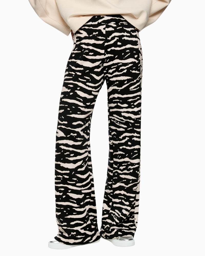 Marc Cain WELKOM wide-leg trousers with animal print black front view on woman wearing them – Áines Boutique
