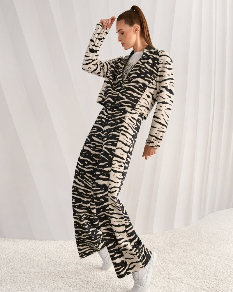 Marc Cain WELKOM wide-leg trousers with animal print black full length on model – Áines Boutique