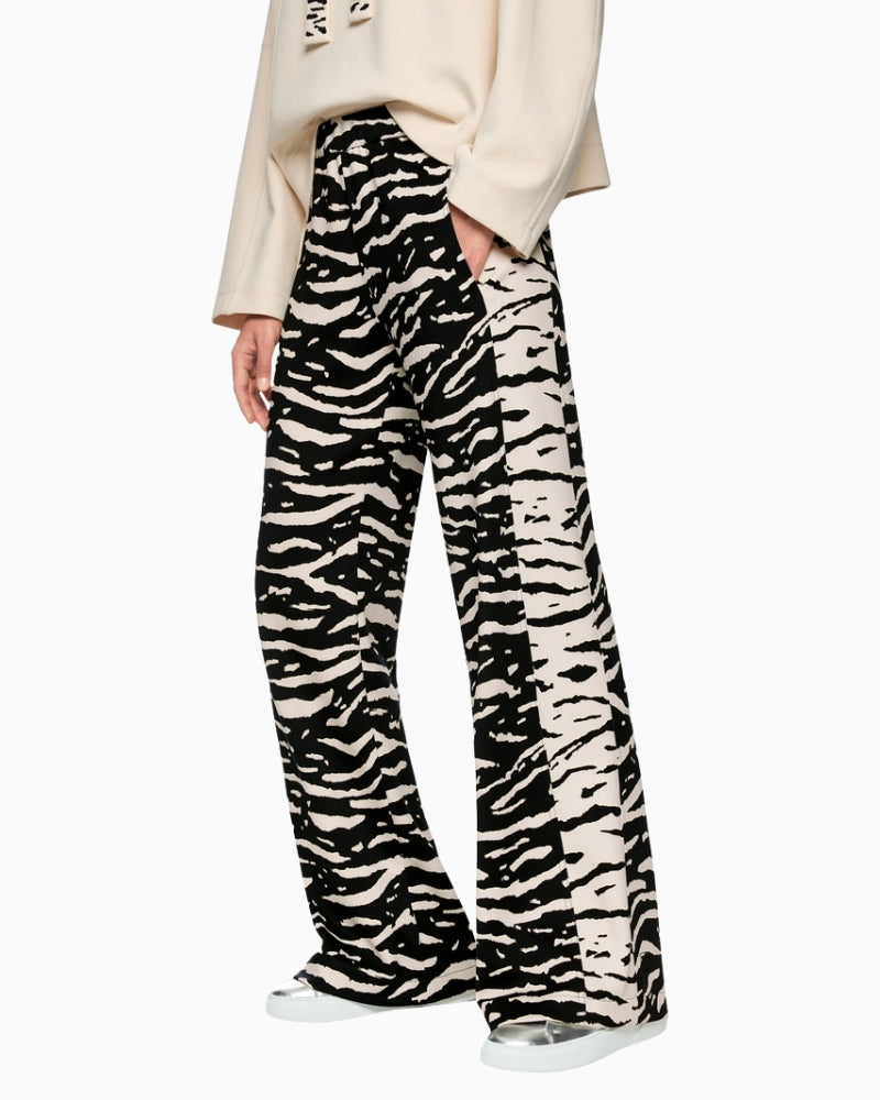 Marc Cain WELKOM wide-leg trousers with animal print black side view on woman wearing them – Áines Boutique