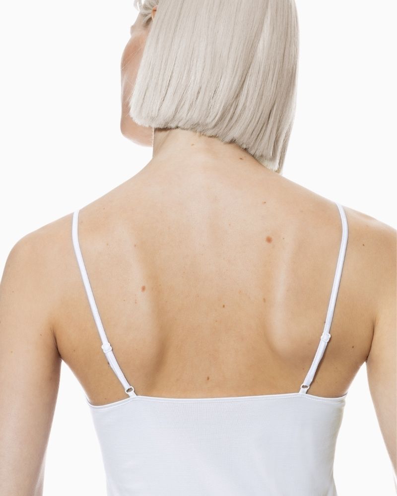 Close up of White spaghetti strap cami by Mey with seamless finish and slim fit