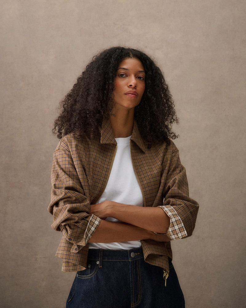 Model wearing cropped tartan shirt jacket with white background studio shot