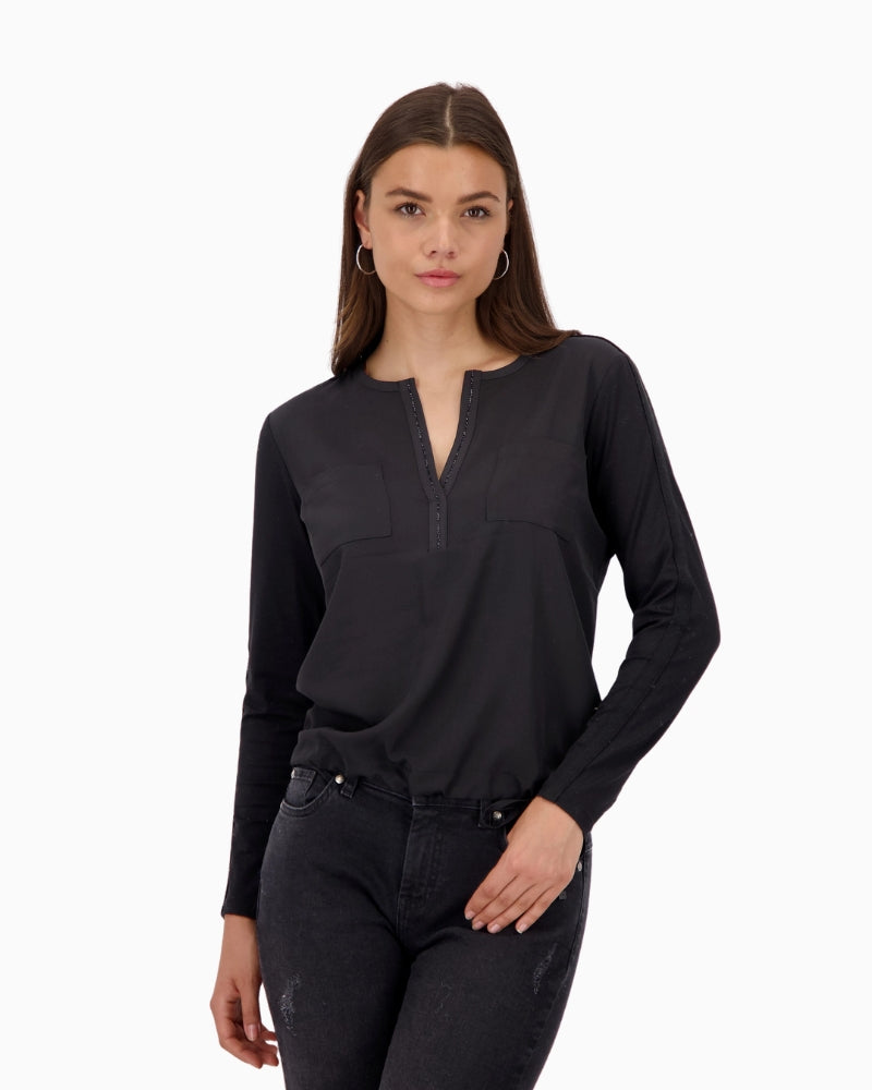 Front view of Monari black blouse with satin-look front and rhinestone neckline