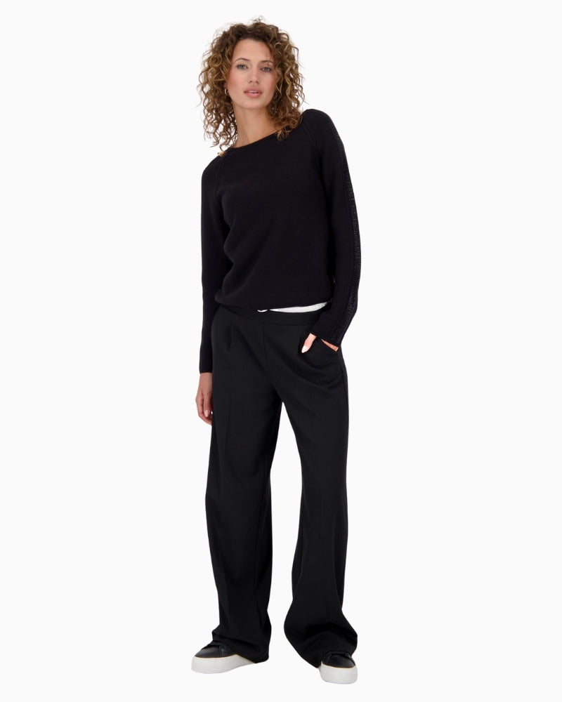 Monari black knit top styled with trousers for a polished casual outfit
