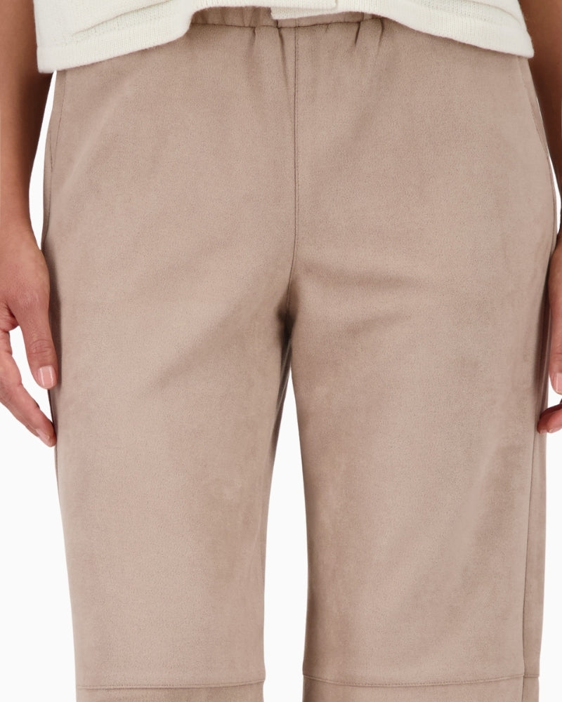 Close-up of olive suede-look fabric and elasticated hem detail