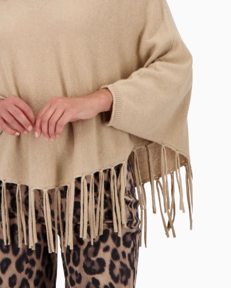 Close up of Monari taupe poncho with V-neck, fringes and flowing fabric