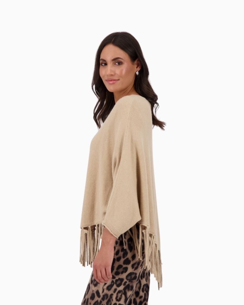 Side view of Monari oversized poncho showing relaxed drape and ¾ sleeves