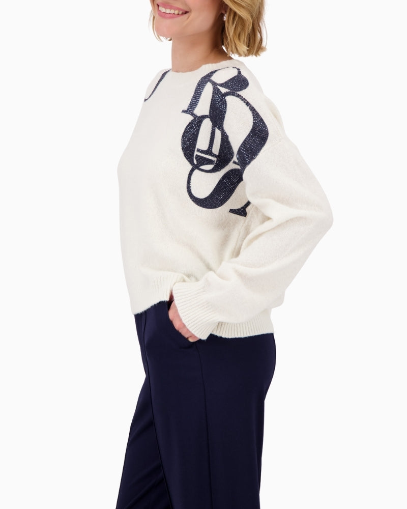 Side view of soft white knit jumper with long sleeves