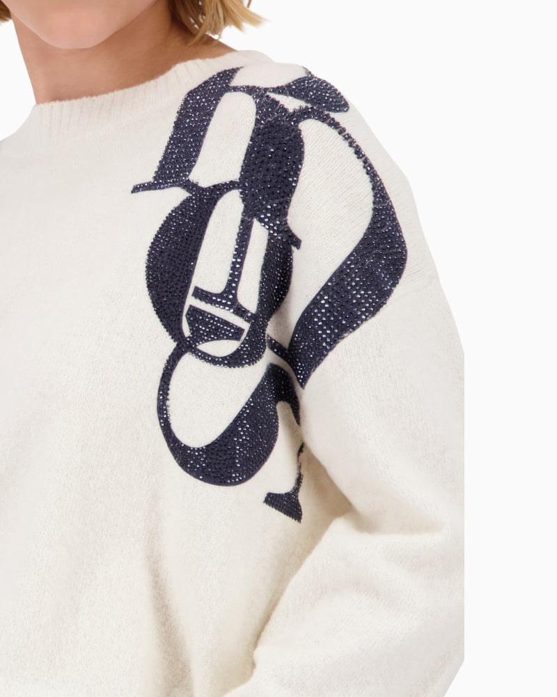 Close-up of printed lettering detail on Monari sweater