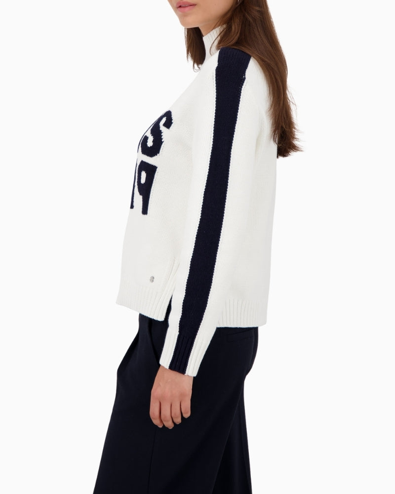 Side view of soft white knit jumper with button trim