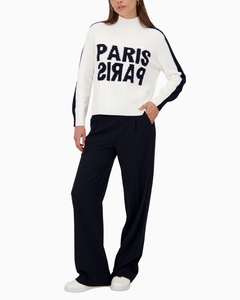 Model wearing Monari white jumper styled with casual trousers