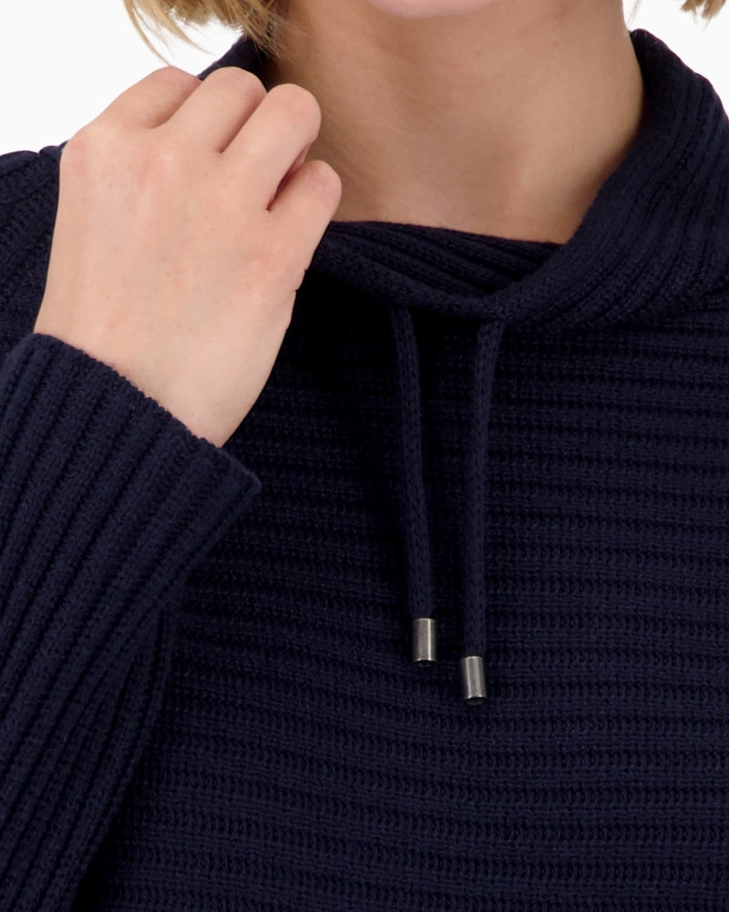 Close-up of rib knit texture on navy cotton and acrylic jumper