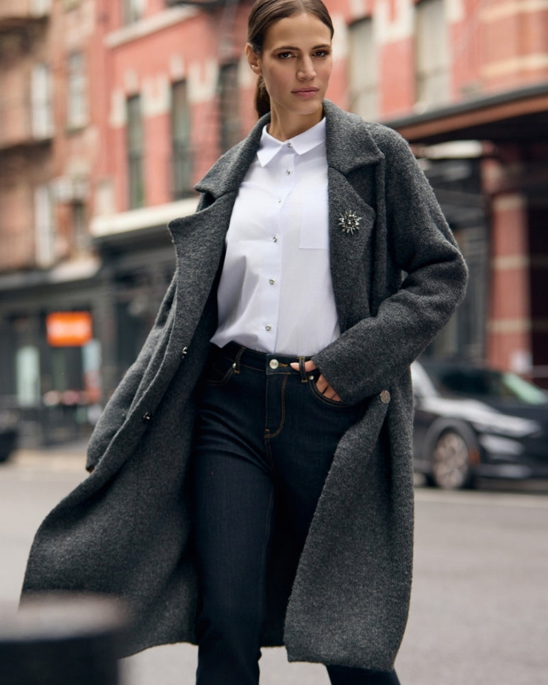 White long-sleeve blouse styled with trousers for a polished look