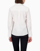 Back view of blouse showing pleat detail and soft poplin fabric