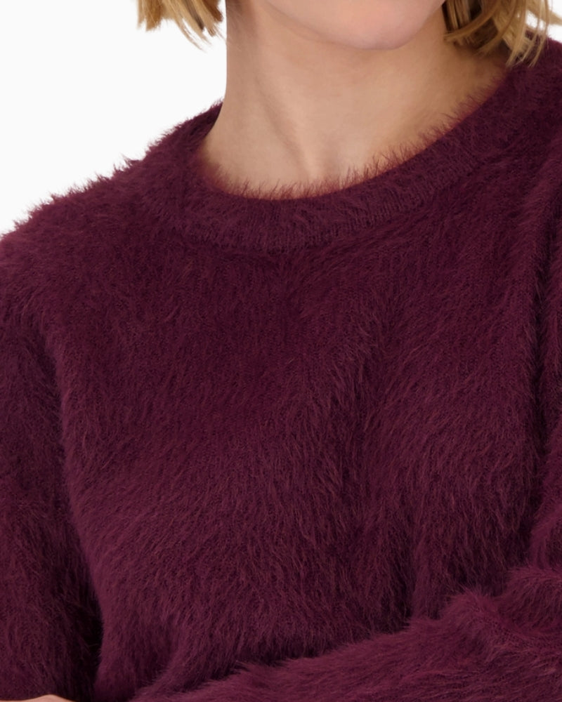Close-up of soft cotton blend knit texture in deep Bordeaux