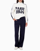 Smart casual trousers styled with knit top and trainers