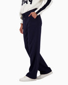 Side view of relaxed fit trousers with front crease and tie detail