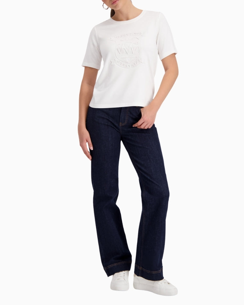 Woman wearing Monari T-shirt with emblem off white styled casually – Áines Boutique