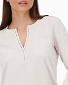 Close-up of rhinestone neckline and satin texture