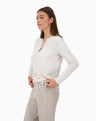 Side view showing stripe detail on sleeves and flowing fabric