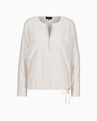 Full front view of beige blouse with drawstring hem and patch pockets