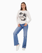 Model wearing Monari long sleeve top with denim jeans and rubber shoes