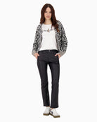 Model wearing straight-leg black trousers with shoes and jumper