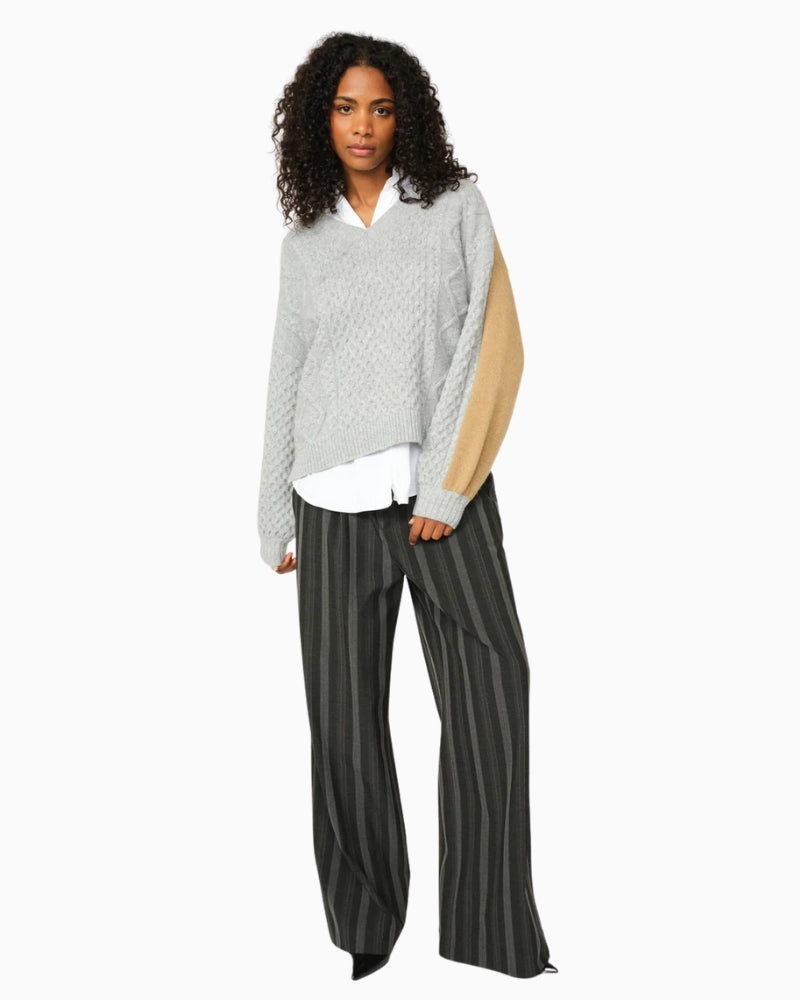 Side view of striped tailored trousers with pleat detail