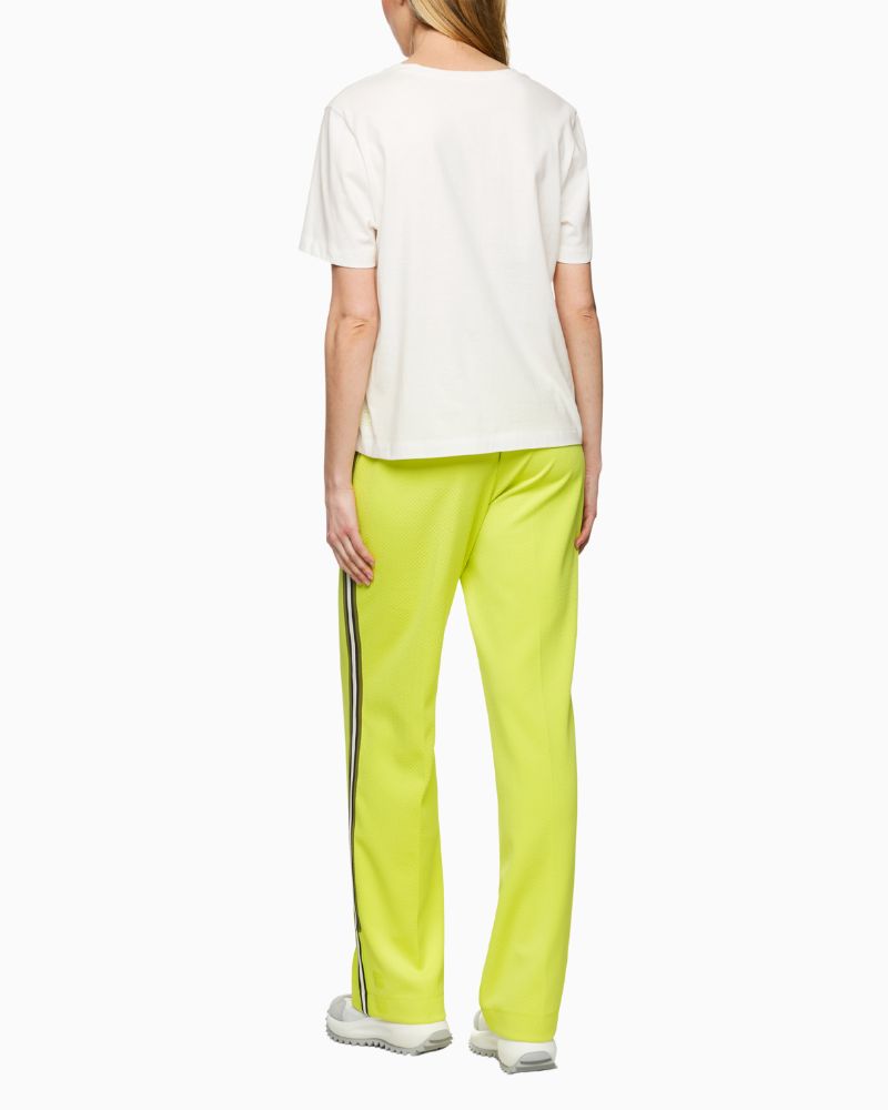 Back view of white Mos Mosh tee with graphic leopard wearing rucksack