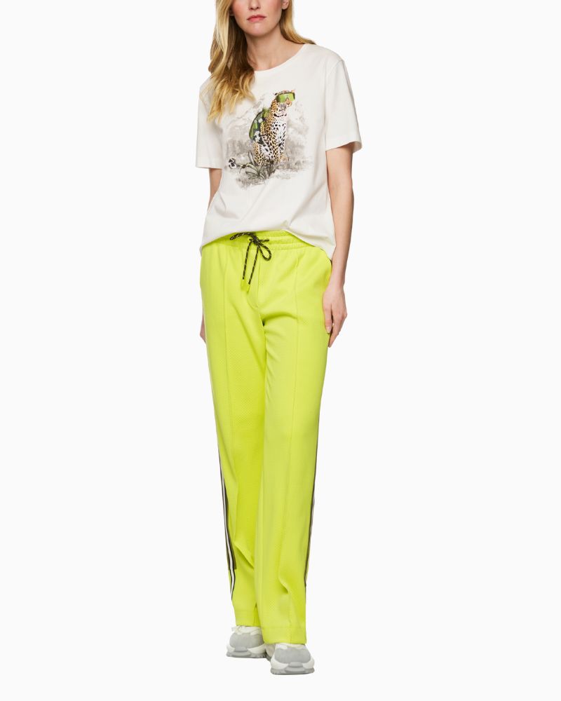 Front view of white Mos Mosh tee with graphic leopard wearing rucksack