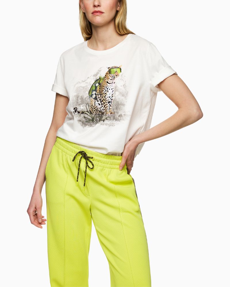 Front view of white Mos Mosh tee with graphic leopard wearing rucksack