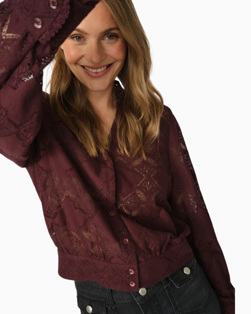 Close-up of neckline and cuff design on Monia Yen lace shirt