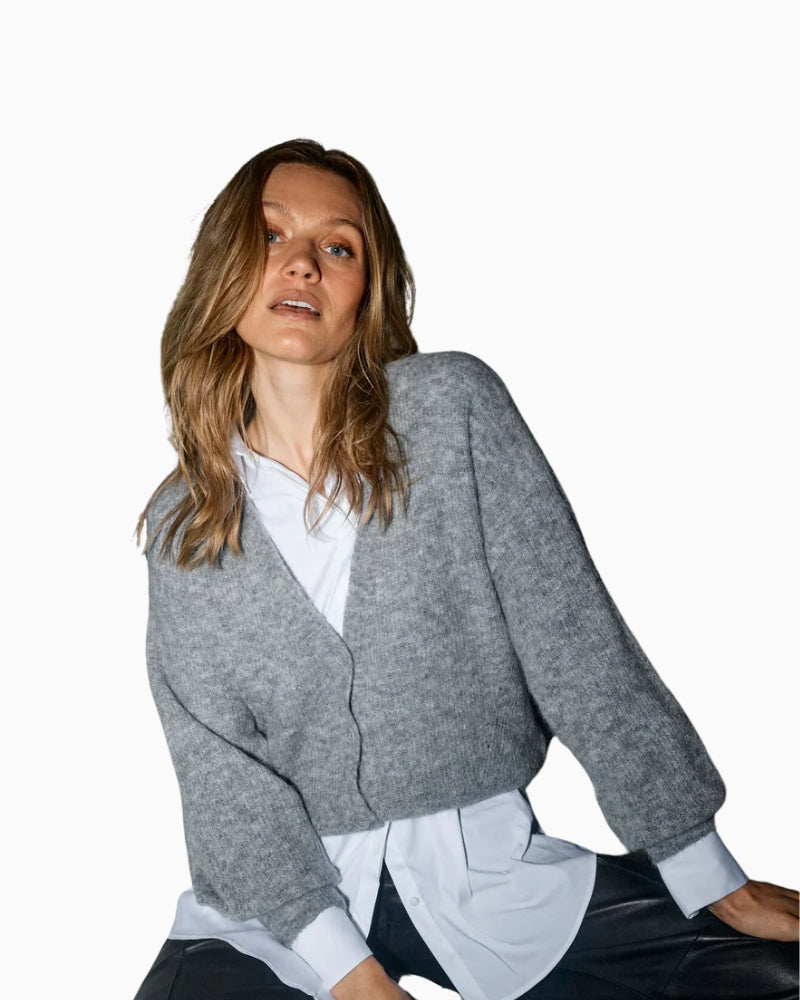 Close-up of V-neckline and ribbed button detail