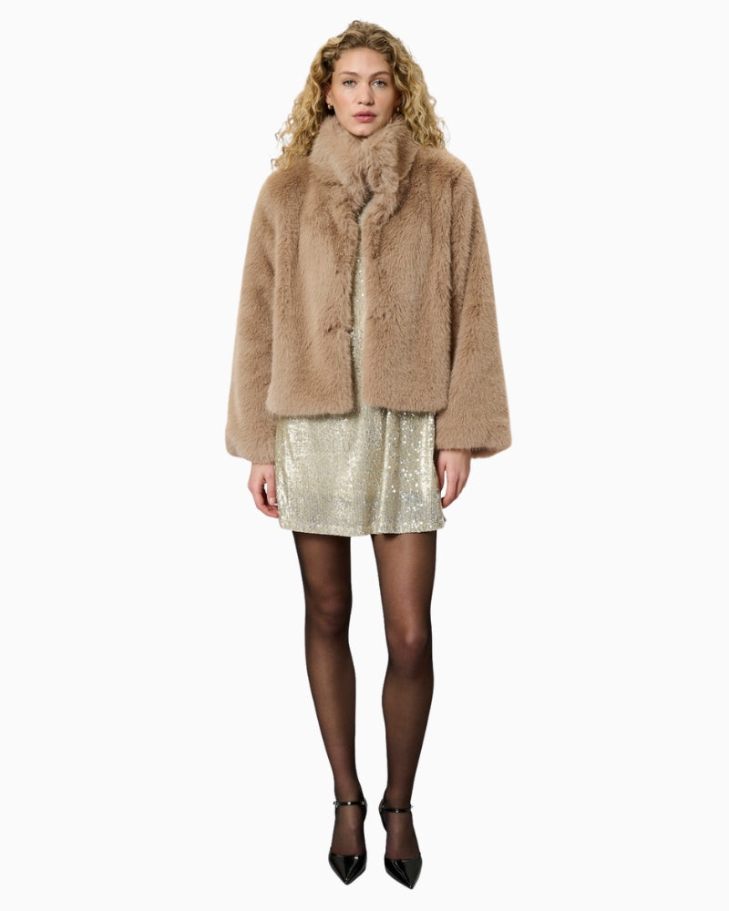 Model wearing Alexa jacket layered over jeans and boots