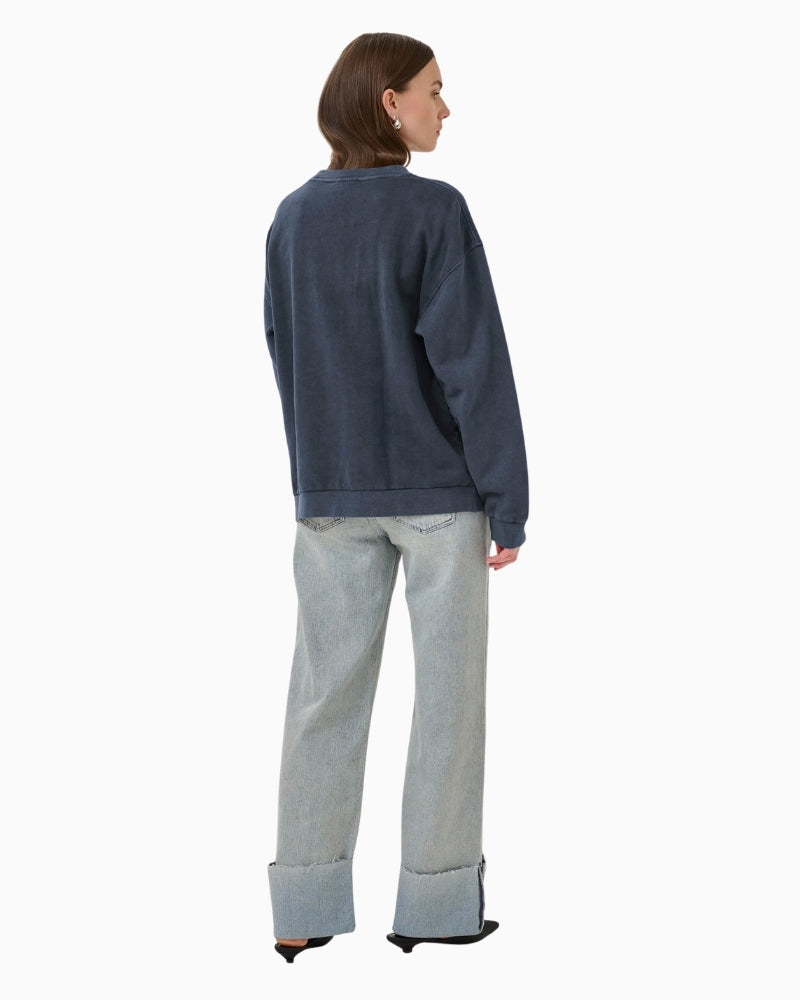 Back view of long sleeve crewneck sweatshirt with dropped shoulders