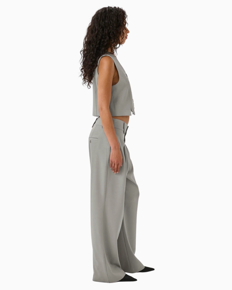 Side view of Disa trousers with pleat detail and soft drape