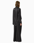 Side angle showing relaxed fit and long tailored sleeves
