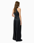 Back view of high-waisted trousers with tailored waistband and soft drape