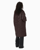 Back view of padded longline bomber coat in smooth polyamide fabric