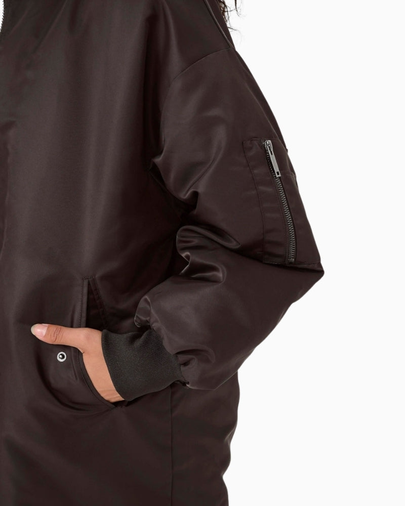 Close up of profile showing mid-calf length and straight silhouette of women's bomber coat