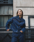 Front view of Malle denim jacket with boxy fit, patch pockets, and button closure