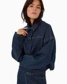 Side view showing relaxed shape and shirt collar on casual denim jacket