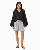 Model view A-line blue denim mini skirt by My Essential Wardrobe with panel seams