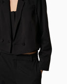 Detail of blazer hemline and structured fit at waist