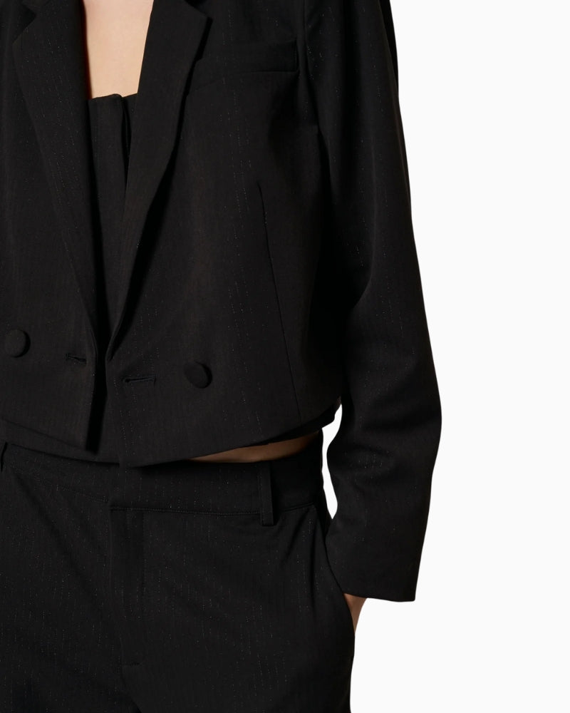 Detail of blazer hemline and structured fit at waist