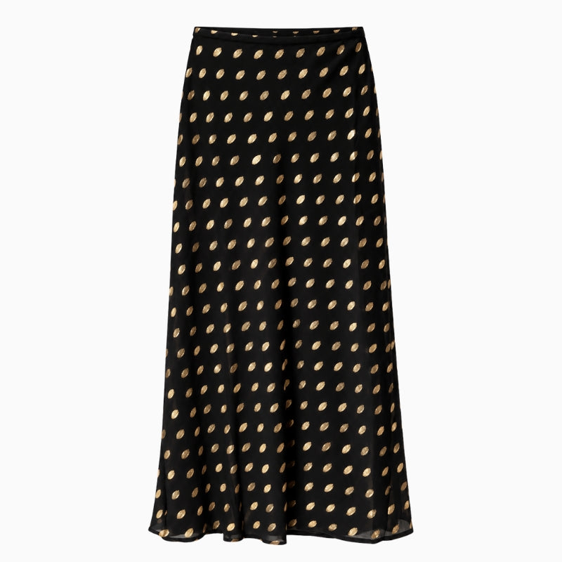 Never Fully Dressed Dorris Skirt in Black front view showing metallic gold polka dots and flowing maxi silhouette