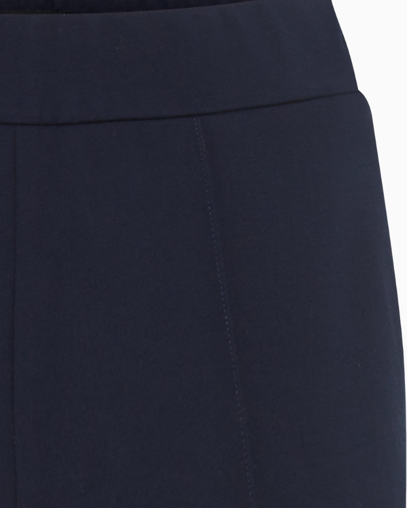 Close-up of smooth navy stretch fabric on cropped trousers