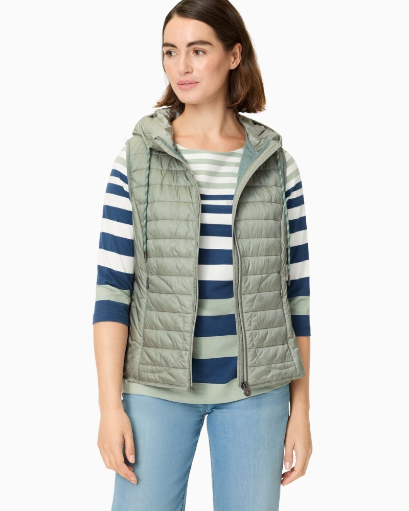 Woman wearing Olsen sage green padded hooded vest styled casually – Áines Boutique