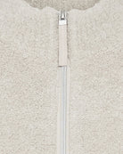 Close-up of plush faux fur fabric and collar detail on beige Olsen vest