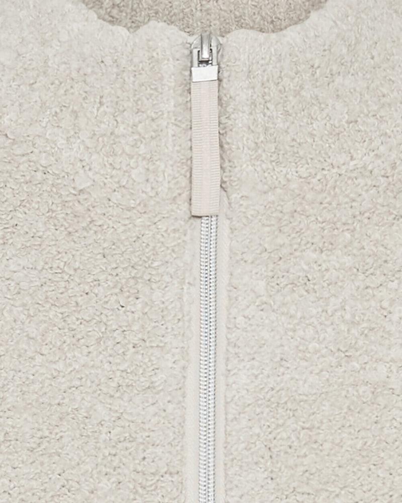 Close-up of plush faux fur fabric and collar detail on beige Olsen vest